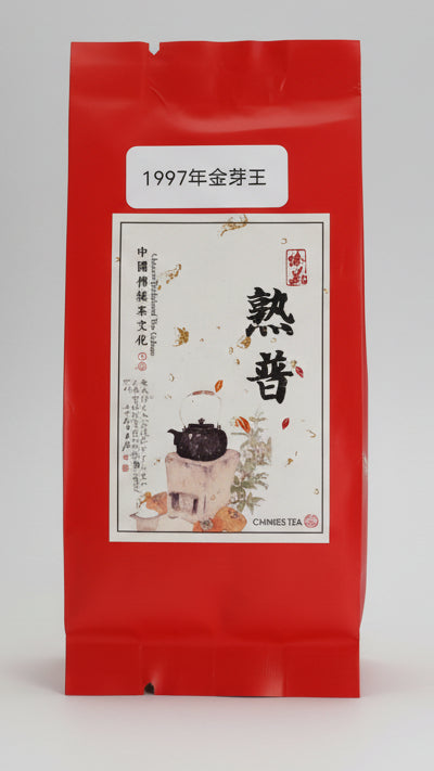 A red packet of 1997 Pu'er ripe tea with a label showing the tea's name and an image of a pot and leaves.