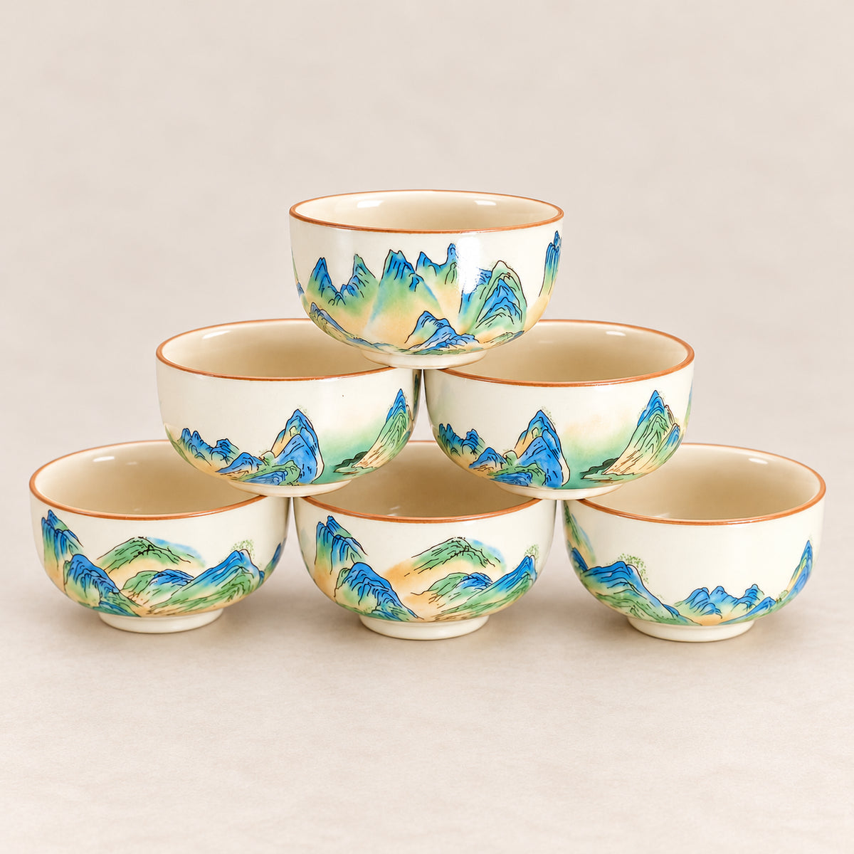 Six matching Qianli Jiangshan tea cups displayed together