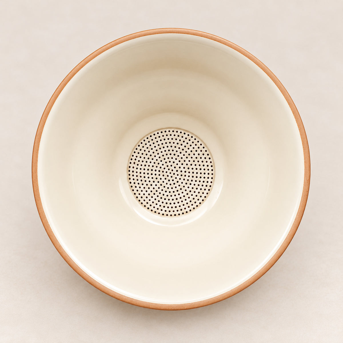 Perforated ceramic tea strainer seen from above